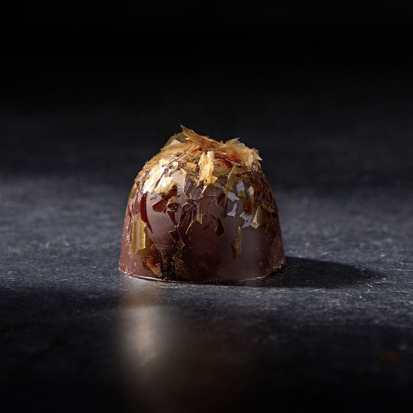 Dark Chocolate Truffle with hazelnut paste and a sprinkle of Lion’s Mane gold.