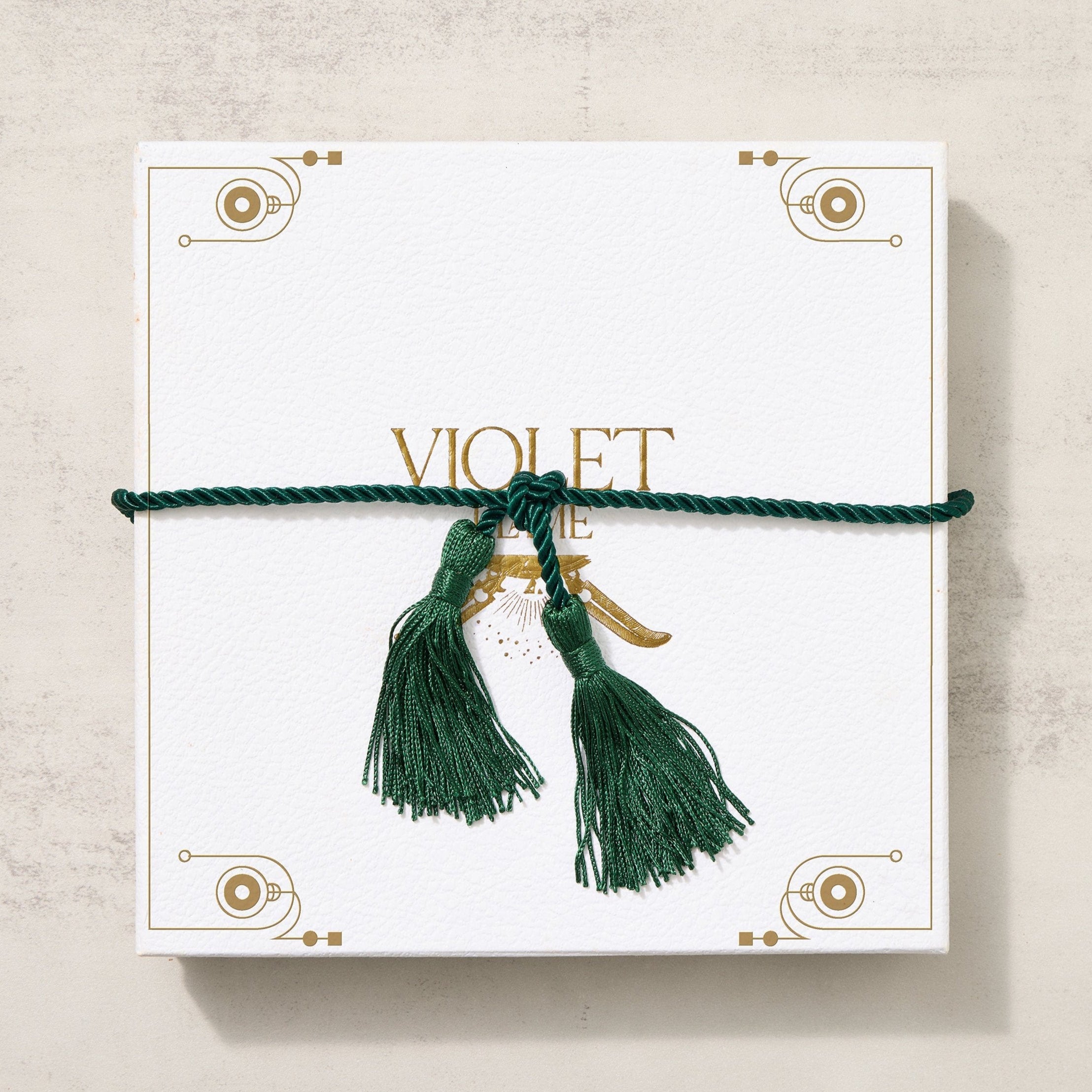 White Violet Flame Box tied with a vibrant green tassel