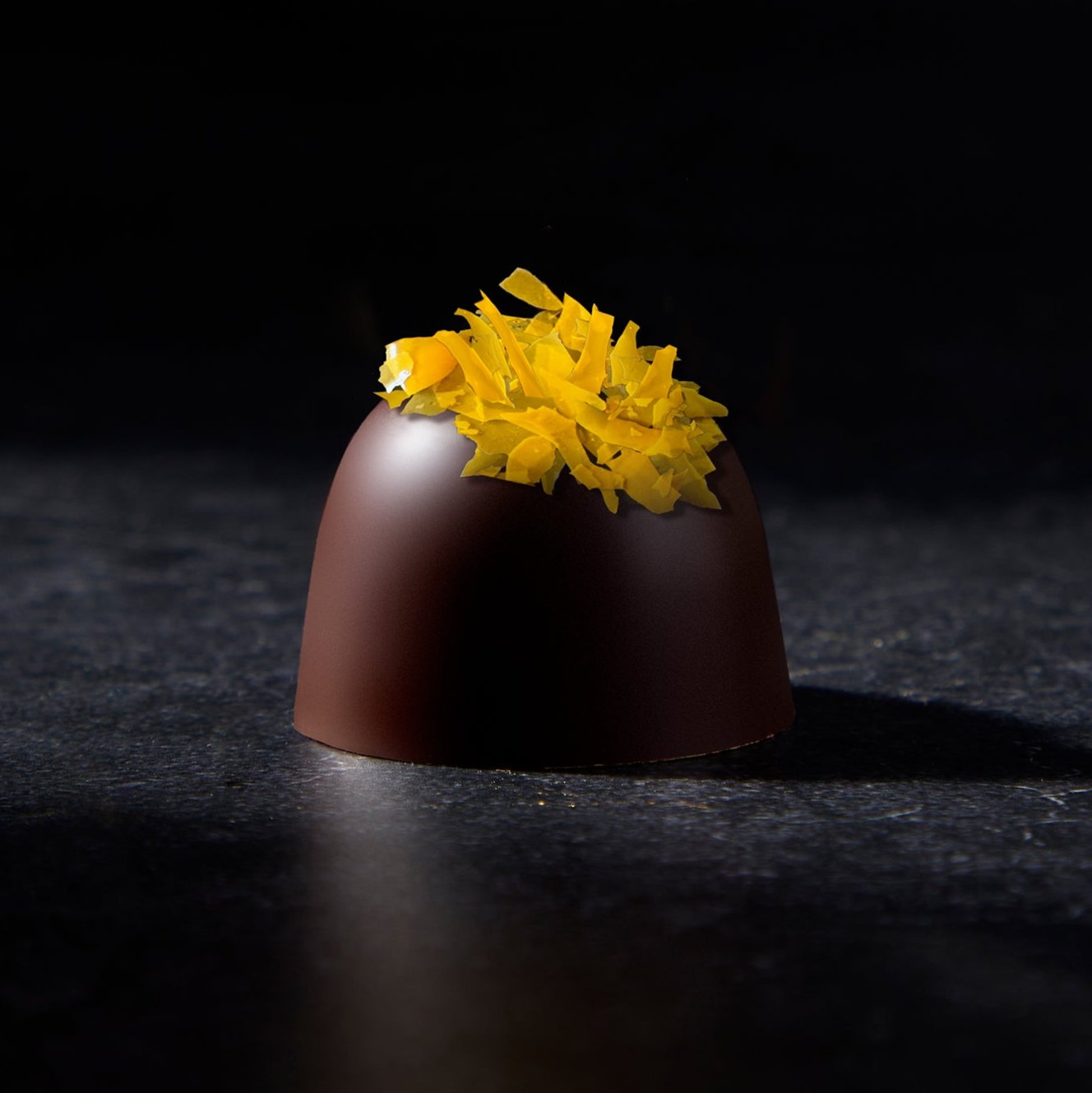 Chocolate Truffle topped with freshly grated turmeric in caramelized dark milk chocolate.