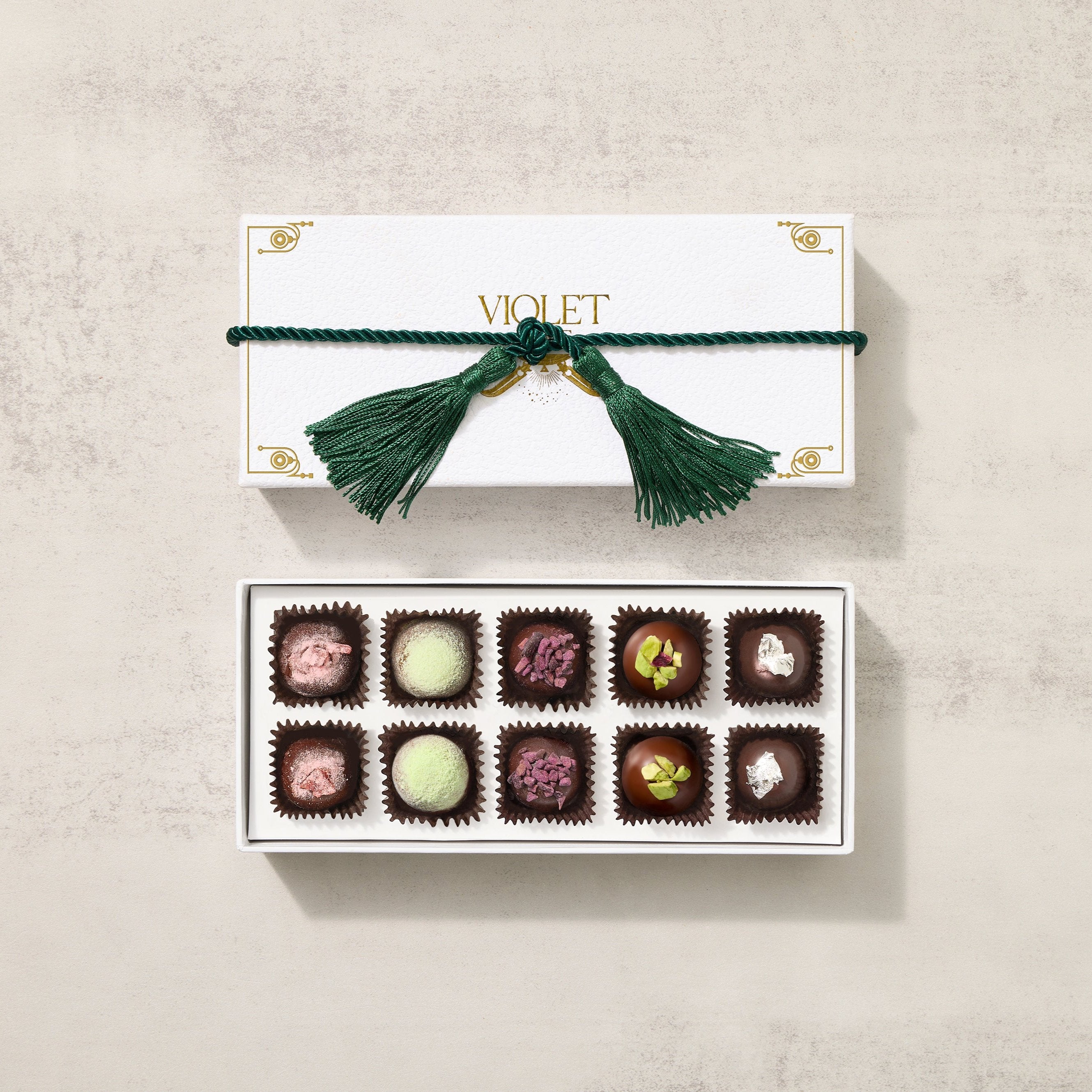 Chocolate Truffle Collection with 10 pieces of assorted milk chocolate and dark chocolate inside a white gift box tied with a beautiful green ribbon.